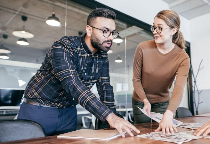 man and woman at office desk